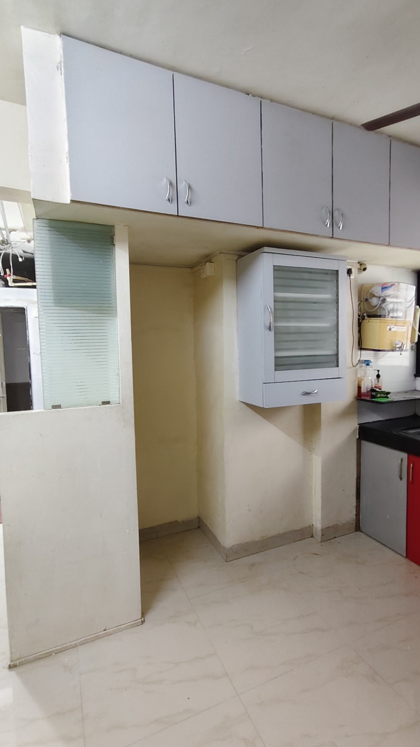 Kitchen storage cabinets in semi furnished Kothrud rental flat